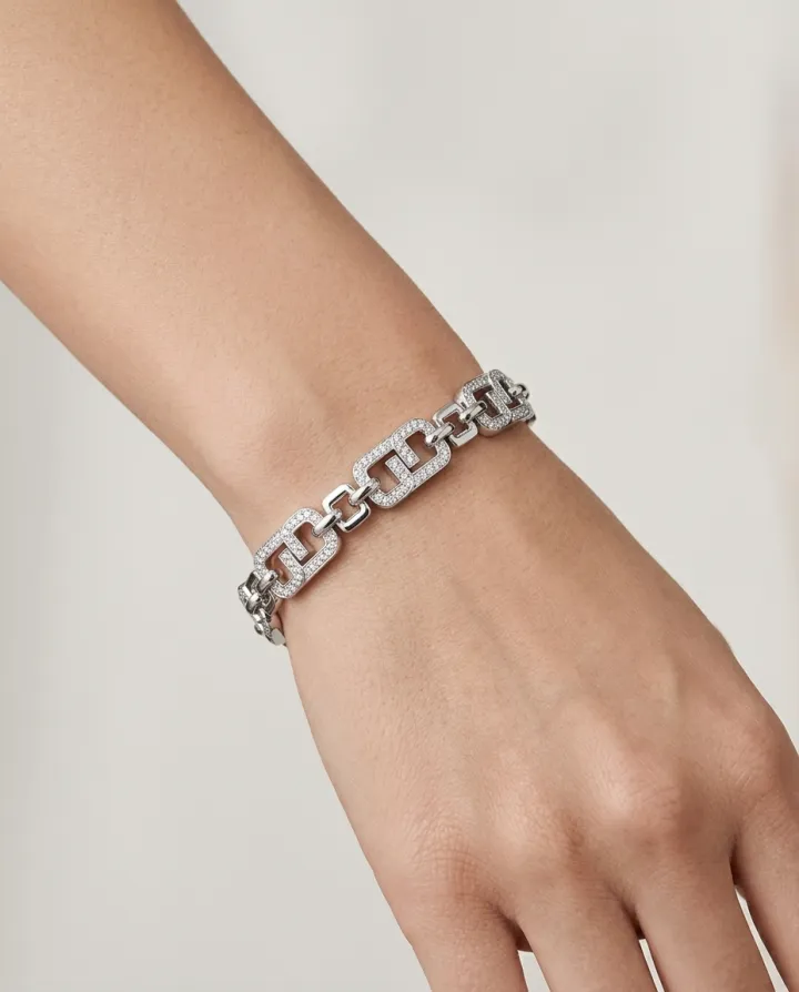 A bracelet worn on a model’s wrist, styled for a social post.