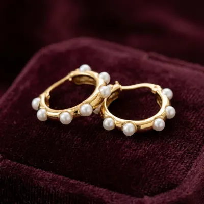 A jewellery piece resting on dark velvet, photographed close.