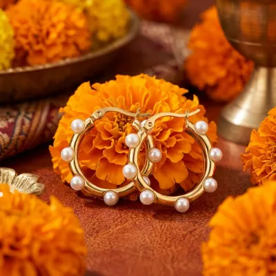 Jewellery arranged among marigold flowers.